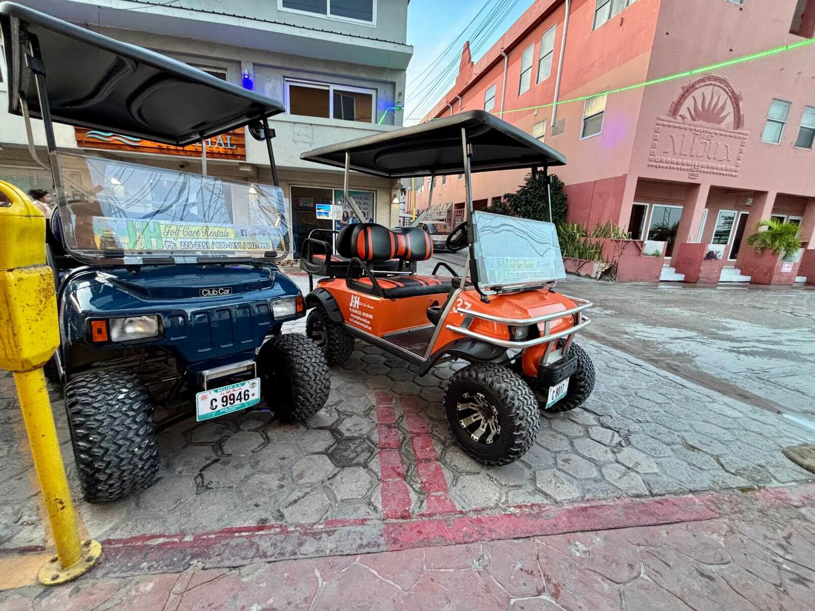 Blue and orange golf carts parked side by side in San Pedro