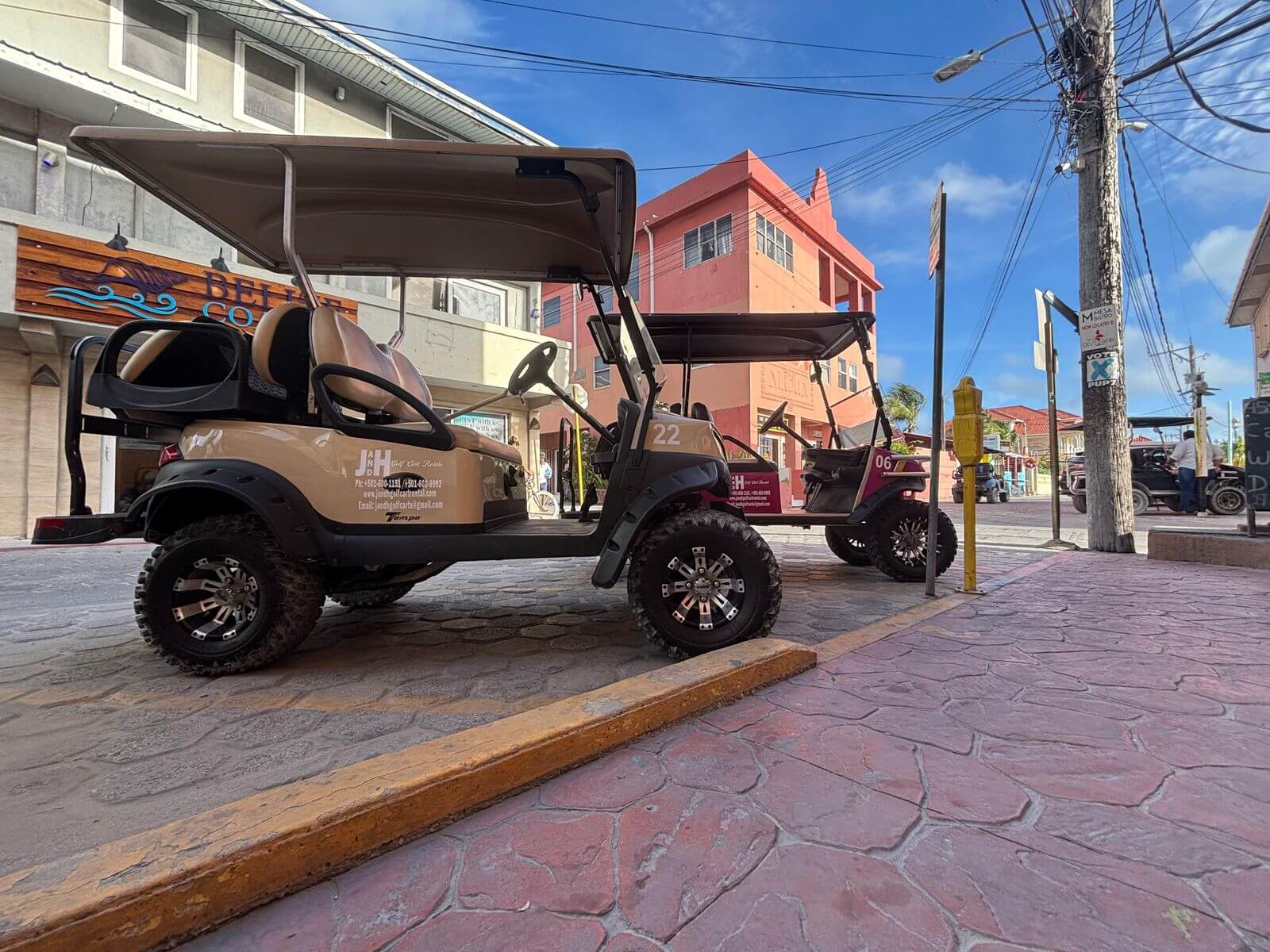 Bronze golf cart on a colorful paver street in San Pedro