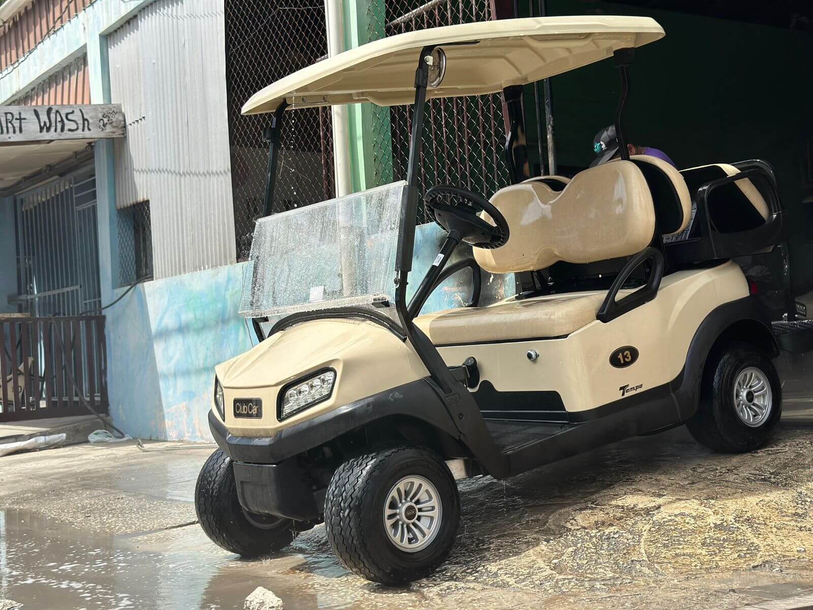 Clean tan 4-seater golf cart profile in San Pedro, Belize